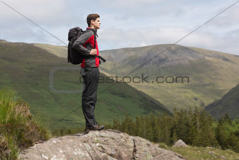 Man standing at hill top admiring the view