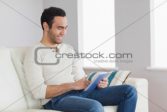 Happy casual man using his tablet