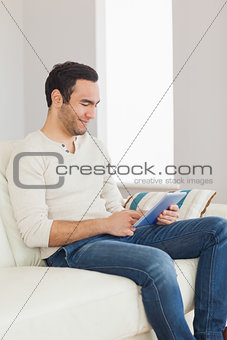 Relaxed casual man using his tablet