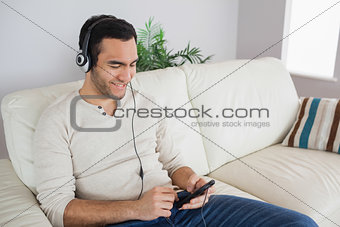 Smiling handsome man listening to music