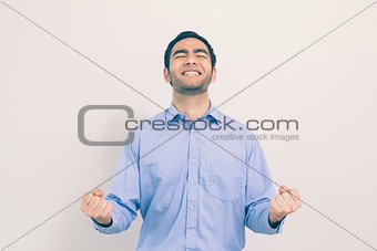 Victorious man standing clenching his fists