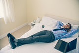 Cheerful man relaxing on his bed