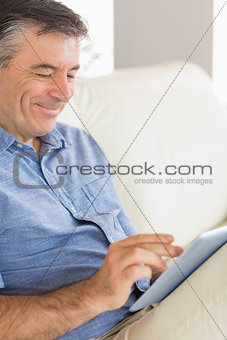 Smiling man using a tablet pc