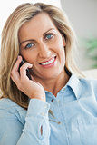 Smiling woman calling someome with her mobile phone