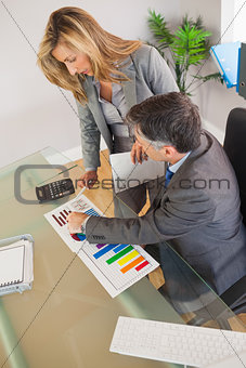 Two business people looking at documents in an office