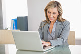 Businesswoman using a laptop in an office