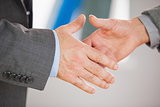 Two people going to shake their hands