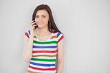 Smiling girl calling with her mobile phone looking at camera