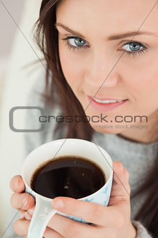Happy girl holding a cup of coffee