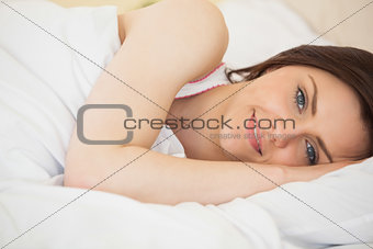 Smiling girl lying on a bed
