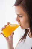 Relaxed girl drinking a glass of orange juice