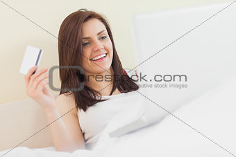 Excited girl using her laptop to shop online