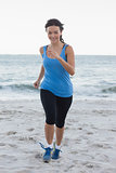 Sporty woman running at the beach