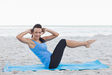 Woman doing abdominal crunches on exercise mat