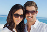 Smiling couple wearing sunglasses and looking at camera