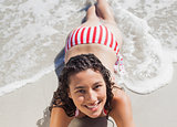 High angle view of smiling woman lying down on beach