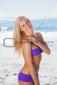 Blonde woman posing and smiling at camera