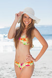 Young smiling woman in bikini standing with her hand on her hip