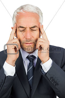 Focused businessman holding his temples