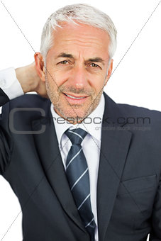 Businessman looking at camera touching his painful neck