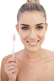 Joyful woman holding a toothbrush