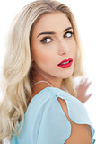 Portrait of a wondering blonde model in blue dress looking away