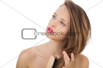 Dreamy brunette model brushing her hair