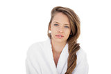 Attractive brunette in bathrobe looking at camera