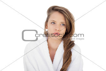 Wondering brunette in bathrobe looking away