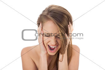 Upset brunette model holding her head and screaming