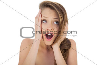 Shocked brunette model holding her head