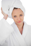 Content brunette in bathrobe looking at camera