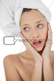 Schocked brunette drying her hair looking away