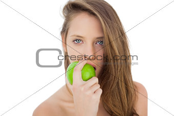 Wondering brunette model eating an apple