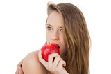 Attractive brunette model eating an apple