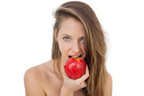 Pretty brunette model eating an apple