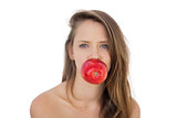 Pretty brunette model holding an apple in her mouth
