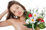 Attractive brunette model holding a bouquet of flowers