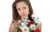 Calm brunette model holding a bouquet of flowers