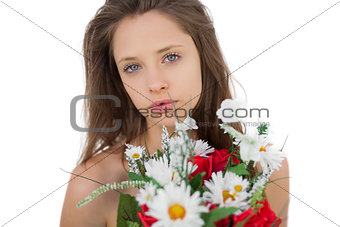 Calm brunette model holding a bouquet of flowers