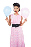 Amused black hair model holding balloons