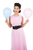 Thoughtful black hair model holding balloons