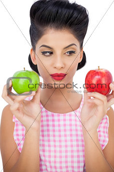 Pensive black hair model holding apples