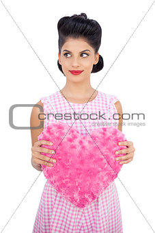 Pretty black hair model holding a pink heart shaped pillow