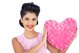 Lovely black hair model holding a pink heart shaped pillow