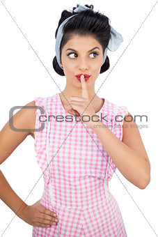 Charming black hair model posing a finger on the mouth