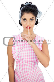 Attractive black hair model posing a finger on the mouth