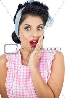 Surprised black hair model posing with a hand on the cheek