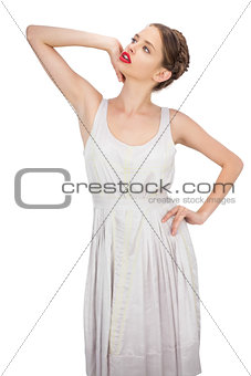 Sensual model in white dress posing looking away