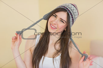 Funny pretty girl trying on a wool hat